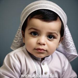 A baby wearing a white headscarf and necklace, looking adorable and innocent