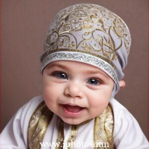 A baby wearing a white headscarf and necklace, looking adorable and innocent