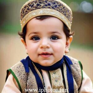 A baby wearing a white headscarf and necklace, looking adorable and innocent