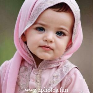 A cute baby girl with a pink headscarf