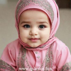 A cute baby girl with a pink headscarf