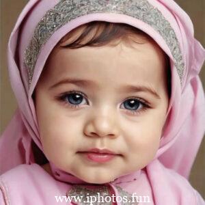 A cute baby girl with a pink headscarf